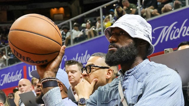 LeBron James throws the ball back to a referee as he attends a 2025 NBA Summer League game between the Lakers and the New Orleans Pelicans.