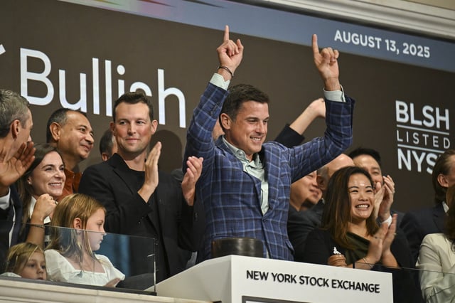 Brendan Blumer (centre left) Bullish chairman, and Tom Farley (centre right), chief executive, celebrate after ringing the opening bell at the New York Stock Exchange