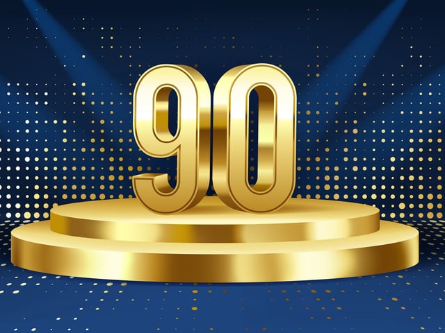 The number 90 in gold on a pedestal.