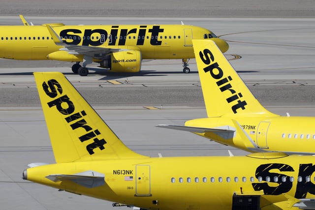 A Spirit Airlines Airbus A320 taxis at Harry Reid International Airport behind parked aircraft on March 15, 2025 in Las Vegas, Nevada.