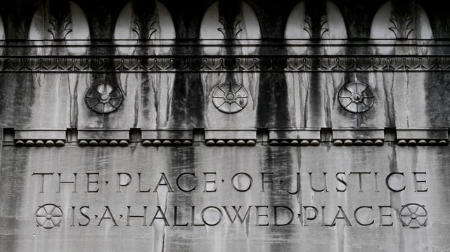 WASHINGTON, D.C.—JULY 19: Etchings are seen on the walls near an entrance to the Department of Justice building on July 19, 2025, in Washington, D.C.