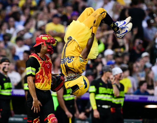 Savannah Bananas player Flash Tha Kid flips as he crosses the plate against the Firefighters at Coors Field on Saturday, Aug. 9, 2025, in Denver. (Andy Cross/Denver Post)