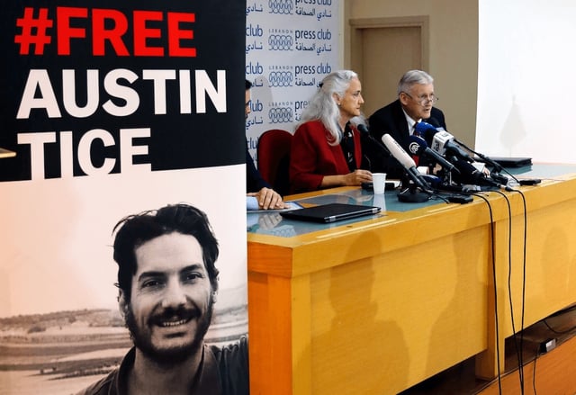 Debra and Marc Tice, the parents of Austin Tice, who is missing in Syria, speak during a press conference next to a poster of their son, in 2018. (AP Photo/Bilal Hussein)