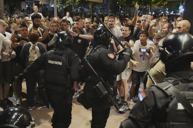 Serbian gendarmerie officers separate protesters from opposing camps during an anti-government protest in Belgrade, Serbia, Wednesday, Aug. 13, 2025. (AP Photo/Darko Vojinovic)