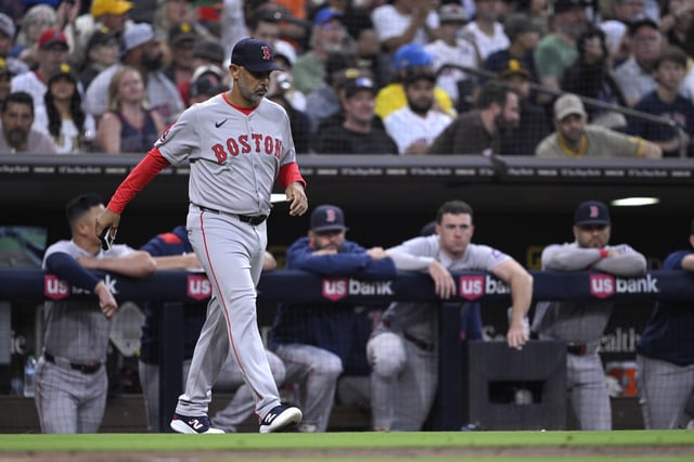 SAN DIEGO, CALIFORNIA - AUGUST 09: Manager Alex Cora #13 of the Boston Red Sox walks to the mound during the fifth inning against the San Diego Padres at Petco Park on August 09, 2025 in San Diego, California.