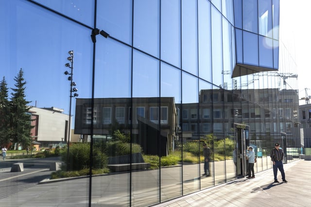 Bank customers exit Lithuania's UAB Urbo Bankas, which was imposed sanctioned by the Chinese Ministry of Commerce on Wednesday, in Vilnius, Lithuania, Thursday, Aug. 14, 2025. (AP Photo/Mindaugas Kulbis)