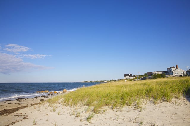Sand, grass, beach, Buzzard's Bay, sky  near beach homes at Falmouth, Cape Cod, Massachusetts, New England, USA.