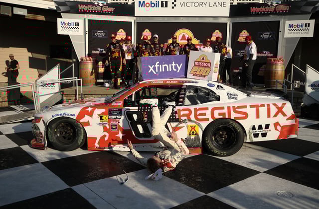 Connor Zilisch, driver of the #88 Registix Chevrolet, slips and falls off his car in victory lane after winning the NASCAR Xfinity Series Mission 200 at The Glen at Watkins Glen International on August 09, 2025 in Watkins Glen, New York.