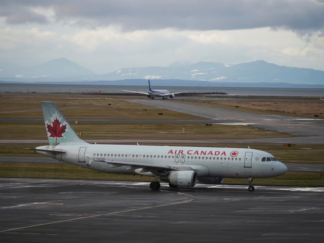 FILE - An Air Canada aircraft taxis at Vancouver International Airport after operations returned to normal after last week's snowstorm, in Richmond, British Columbia, on Monday, Dec. 26, 2022. (Darryl Dyck/The Canadian Press via AP, File