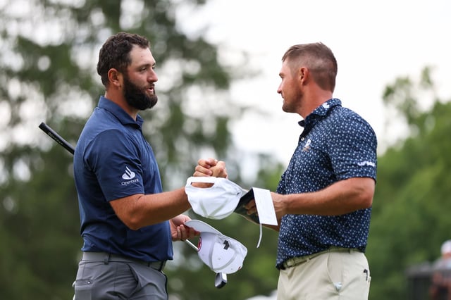 WHITE SULPHUR SPRINGS, WEST VIRGINIA - AUGUST 16: Jon Rahm of Spain hand shakes Bryson DeChambeau of the United States after finishing the 18th hole during day one of LIV Golf: Greenbrier at The Old White Course on August 16, 2024 in White Sulphur Springs, West Virginia. (Photo by Isaiah Vazquez/Getty Images)