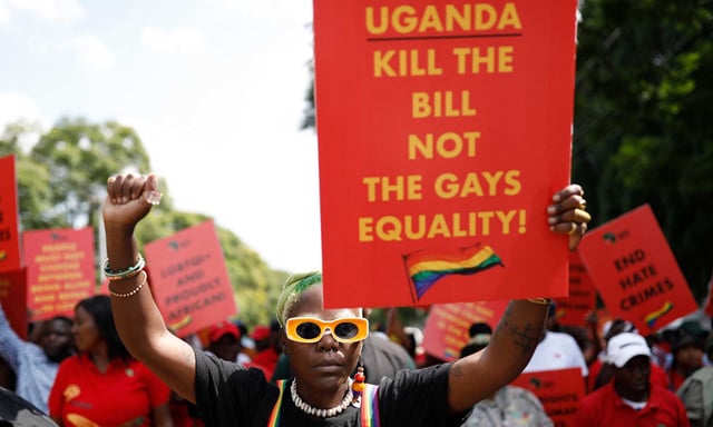 DeLovie Kwagala pictured holding a sign that says &#34;Uganda kill the bill not the gays equality!&#34; (Getty)