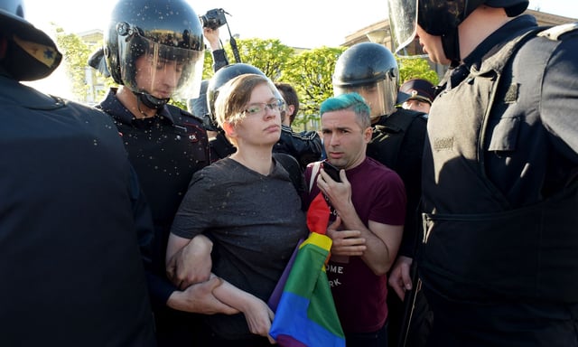 Russian riot police detain LGBTQ+ rights activists during a St Petersburg march. (Getty)