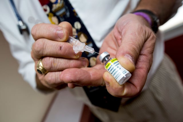This 2015 photo shows a pediatrician preparing a shot of the HPV vaccine for a patient in Cranston, Rhode Island.