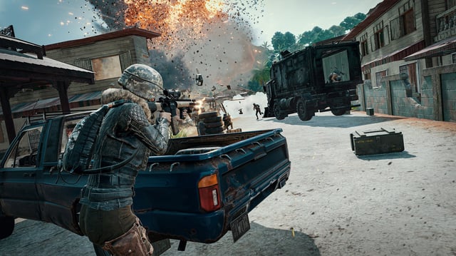 Multiple players in a shootout in a promotional screenshot for PUBG: Battlegrounds