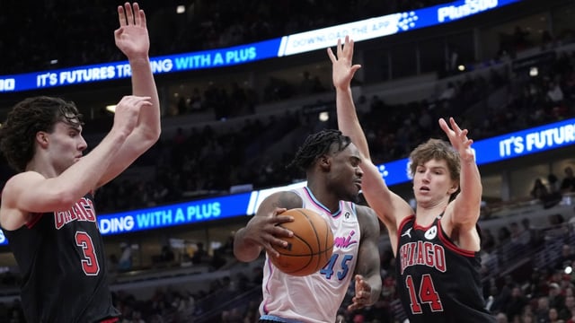 Apr 9, 2025; Chicago, Illinois, USA; Chicago Bulls guard Josh Giddey (3) and forward Matas Buzelis (14) defends Miami Heat guard Davion Mitchell (45) during the second half at United Center. Mandatory Credit: David Banks-Imagn Images