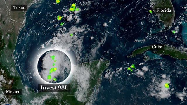 This weather satellite photo of the Gulf of Mexico taken Thursday is superimposed with lightning data and a label to indicate where the most intense thunderstorms were occurring with Invest 98L. The National Hurricane Center expects the tropical system to spend 24 to 48 hours over the western Gulf of Mexico, likely coming ashore in northern Mexico or South Texas by Saturday.