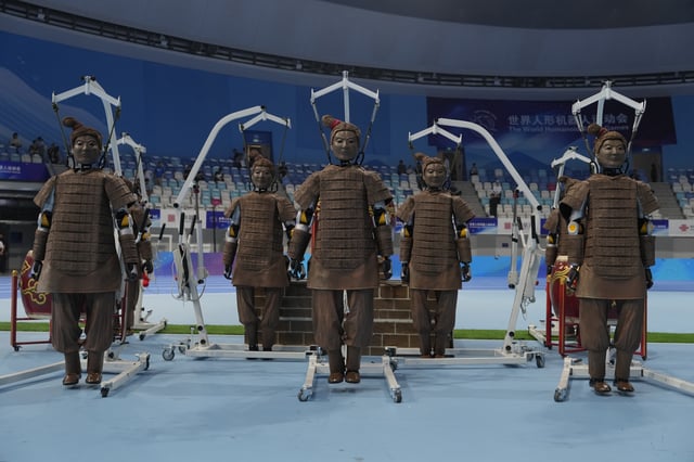 Robots dressed like terracotta warriors are setup before the opening ceremony of The World Humanoid Robot Games held in Beijing, China, Thursday, Aug. 14, 2025. (AP Photo/Ng Han Guan)