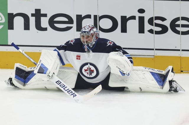 Winnipeg Jets goaltender Eric Comrie warms up before Game 6 of a second-round NHL hockey playoff series against the Dallas Stars in Dallas, Saturday, May 17, 2025. (AP Photo/Gareth Patterson)