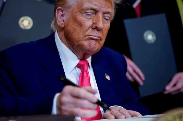 U.S. President Donald Trump signs an energy-related executive order, at the White House in Washington, D.C., U.S., April 8, 2025. REUTERS/Nathan Howard/File Photo