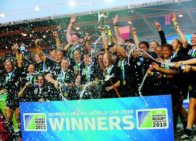 New Zealand players celebrate after defeating England during the Women's Rugby World Cup 2010 Final. (Photo by ADRIAN DENNIS/AFP via Getty Images)