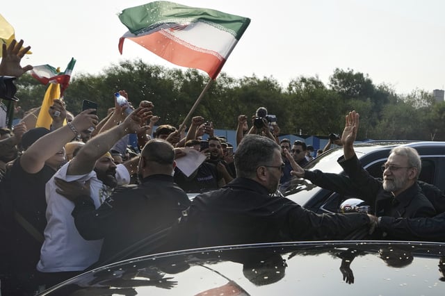 Ali Larijani, right, head of Iran's National Security Council, gestures at Hezbollah supporters outside Rafik Hariri International Airport in Beirut, Aug. 13, 2025 (AP photo by Bilal Hussein).