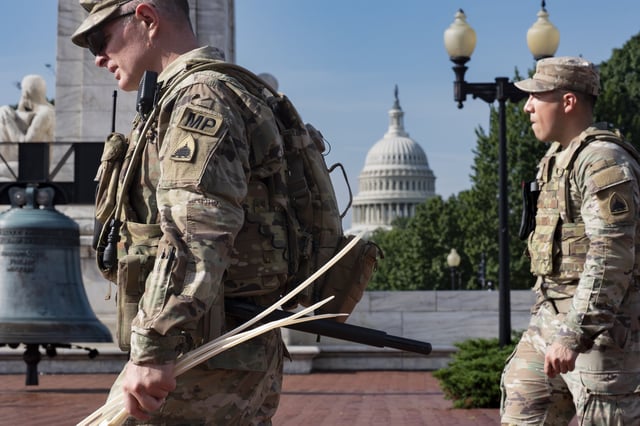 National Guard personnel keep watch as travelers arrive at the entrance to Union Station near the Capitol in Washington, Thursday, Aug. 14, 2025. (AP Photo/J. Scott Applewhite)