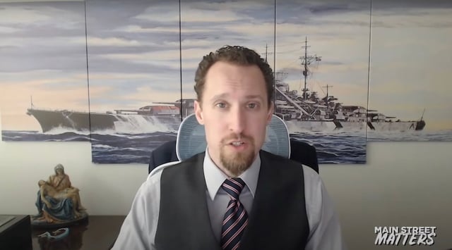 Economist E.J. Antoni is interviewed in front of art depicting the Nazi warship Bismarck, December 9, 2024. In August 2025, President Trump nominated Antoni to lead the Bureau of Labor Statistics. (Screenshot via YouTube)
