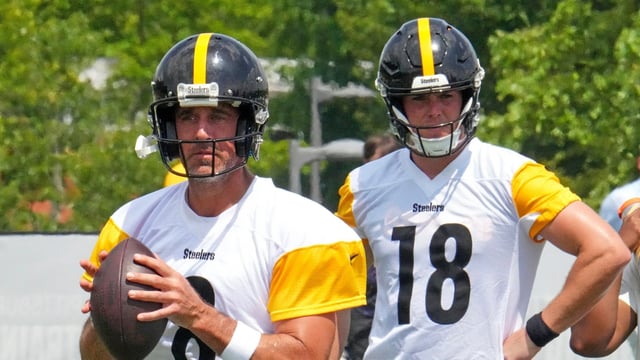 Pittsburgh Steelers quarterbacks Aaron Rodgers (8) looks to pass as Will Howard (18) waits his turn 
