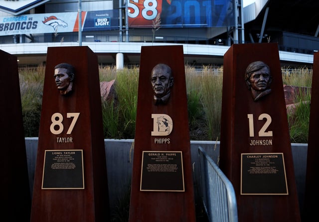 Brian Hanlon&#39;s busts of former Denver Broncos player Lionel Taylor, owner Gerald Phipps and former player Charley Johnson sits in &#39;Ring of Fame Plaza&#39; outside Sports Authority Field at Mile High, home of the Denver Broncos football team in Denver, Colorado on September 12, 2017.