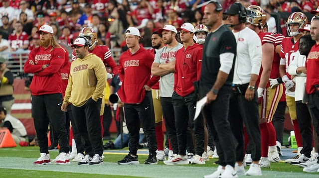 Aug 9, 2025; Santa Clara, California, USA; San Francisco 49ers tight end George Kittle (85), running back Christian McCaffrey (5) and fullback Kyle Juszczyk (44) and quarterback Brock Purdy (13) stand on the sideline in the third quarter against the Denver Broncos at Levi&#39;s Stadium.