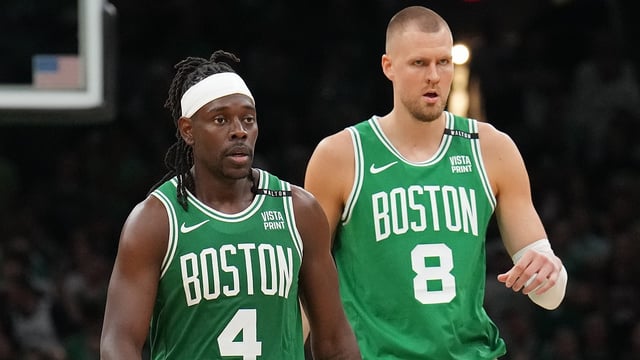 BOSTON, MA – JUNE 17: Jrue Holiday #4 and Kristaps Porzingis #8 of the Boston Celtics look on during the game against the Dallas Mavericks during Game 5 of the 2024 NBA Finals on June 17, 2024 at the TD Garden in Boston, Massachusetts.