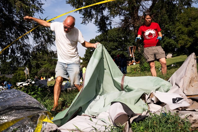 David Beatty and other residents of a homeless encampment near the Kennedy Center in Washington clear their tents with the help of advocates.