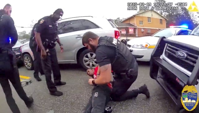 A police officer searches William McNeil Jr, 22, who is pinned on the ground after he was pulled over during a traffic stop, at an unidentified location, in Florida, U.S. February 19, 2025, in this screenshot obtained from a handout video.  Jacksonville Sheriff's Office/Handout via REUTERS/File photo