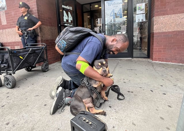 Charles Williams hugs his American Bully dog, Roc, after they were reunited outside the NYPD&#39;s 44th Precinct stationhouse in the Bronx on Thursday, Aug. 14, 2025. (Julian Roberts-Grmela / New York Daily News)