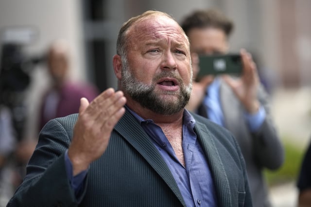 FILE - Right-wing conspiracy theorist Alex Jones speaks to the media after arriving at the federal courthouse for a hearing in front of a bankruptcy judge, June 14, 2024, in Houston. (AP Photo/David J. Phillip, File)