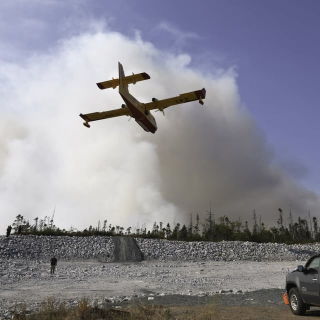 A water bomber makes a pass over the Susies Lake wildfire in Halifax Regional Municipality on Tuesday, Aug. 12, 2025. THE CANADIAN PRESS/Handout - Province of Nova Scotia (Mandatory credit)