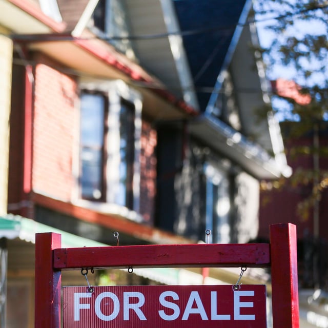 A real estate sign is displayed in front of a house in the Riverdale area of Toronto on Wednesday, September 29, 2021. Greater Toronto Area-home sales rose 10.9 per cent lower in July compared with a year earlier as 6,100 properties changed hands, the most activity recorded in the month since 2021. THE CANADIAN PRESS/Evan Buhler