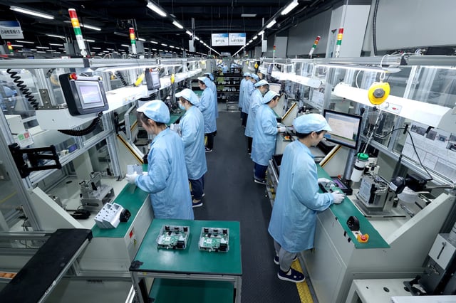 Workers work on a production line manufacturing smart automotive central control navigation products at a factory of Beidou Intelligent Connected Vehicle Technology Co. (BICV) in the High Tech Industrial Development Zone in Suqian, Jiangsu Province, China April 9, 2025. China Daily via REUTERS/File Photo
