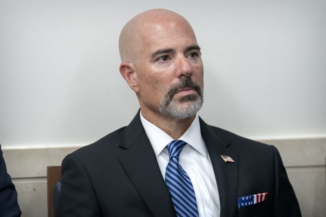 Drug Enforcement Agency Administrator Terrance Cole listens as President Donald Trump speaks with reporters in the James Brady Press Briefing Room at the White House, Monday, Aug. 11, 2025, in Washington. (AP Photo/Mark Schiefelbein)