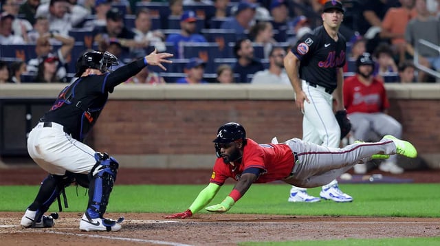 Aug 14, 2025; New York City, New York, USA; Atlanta Braves center fielder Michael Harris II (23) scores against New York Mets catcher Luis Torrens (13) and relief pitcher Ryan Helsley (56) on a double by Braves second baseman Ozzie Albies (not pictured) during the eighth inning at Citi Field. Mandatory Credit: Brad Penner-Imagn Images.