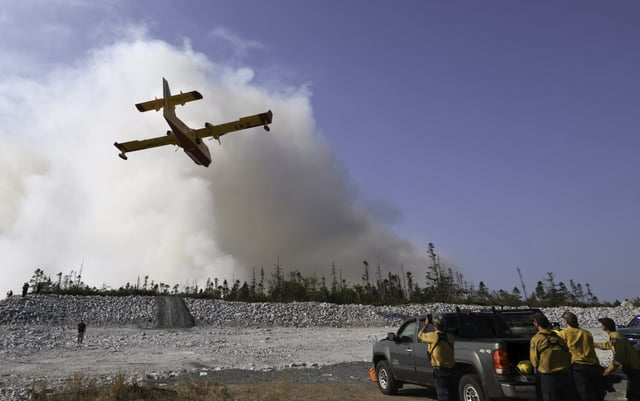 A water bomber makes a pass over the Susies Lake wildfire in Halifax Regional Municipality on Tuesday, Aug. 12, 2025. THE CANADIAN PRESS/Handout - Province of Nova Scotia (Mandatory credit)