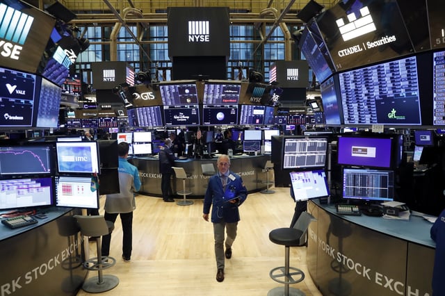 Traders work on the floor of the New York Stock Exchange (NYSE) in New York, U.S., March 19, 2020/ File Photo