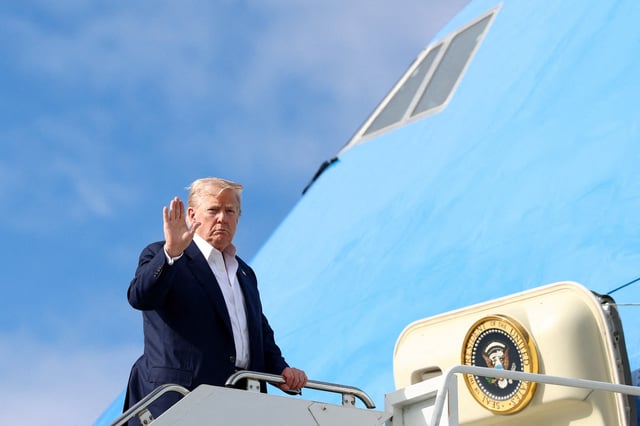 U.S. President Donald Trump gestures while boarding Air Force One as he returns to Washington, D.C., in Lossiemouth, Scotland, Britain, July 29, 2025.