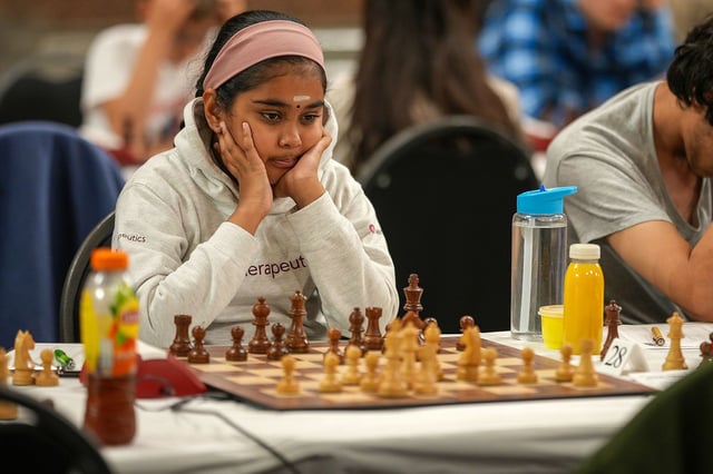 LIVERPOOL, ENGLAND - AUGUST 07: Bodhana Sivanandan, a nine-year-old chess prodigy, competes in the British Chess Championships at St. George's Hall on August 07, 2025 in Liverpool, England. The 111th British Chess Championships are taking place in Liverpool between 31 July to 10 August, with competitors vying for the title in the women's, men's, juniors' and over-60 groups. Organized by the English Chess Federation, the competition has been run annually - apart from war years - since 1904. (Photo by Christopher Furlong/Getty Images)