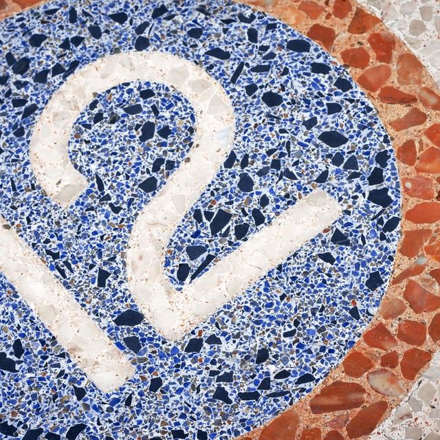 The number 12 displayed on a mosaic floor.