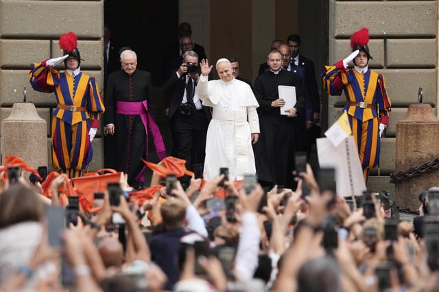 Pope Leo XIV is greeted by faithful as he arrives at the St. Thomas of Villanova Church to celebrate a mass, in Castel Gandolfo, on the outskirts of Rome, Friday, Aug.15, 2025. (AP Photo/Gregorio Borgia)