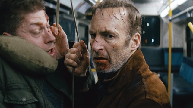 Nobody (2021) (from left) A bus thug (Alain Moussi) and Hutch Mansell (Bob Odenkirk) in Nobody, directed by Ilya Naishuller.