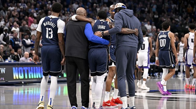Mar 3, 2025; Dallas, Texas, USA; Dallas Mavericks guard Kyrie Irving (11) is helped off the court by forward Naji Marshall (13) and forward Anthony Davis (3) during the second quarter against the Sacramento Kings at the American Airlines Center. Mandatory Credit: Jerome Miron-Imagn Images
