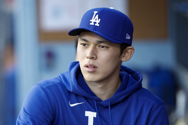 LOS ANGELES, CALIFORNIA - APRIL 28: Roki Sasaki #11 of the Los Angeles Dodgers looks on in the dugout prior to a game against the Miami Marlins at Dodger Stadium on April 28, 2025 in Los Angeles, California. (Photo by Brandon Sloter/Getty Images)