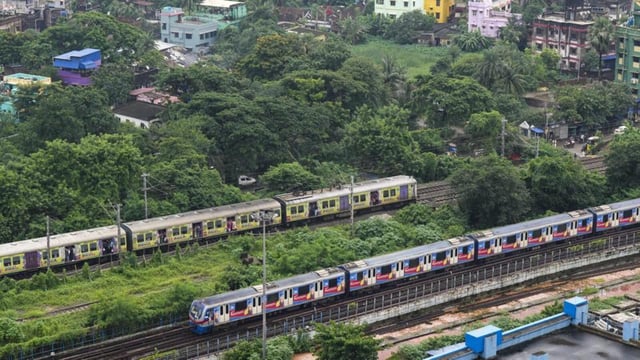 Kolkata: A metro train and an Eastern Railways local train cross each other, in Kolkata (PTI FILE PHOTO)